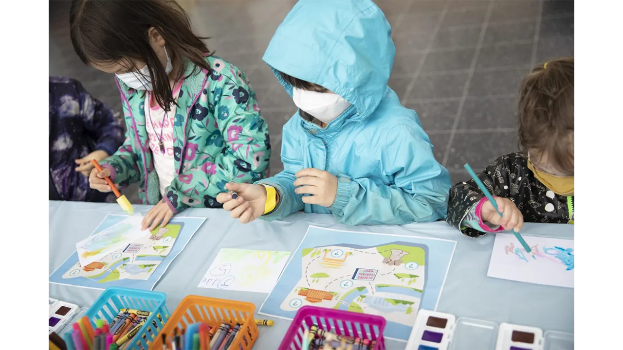 Children creating postcards at the Philadelpia Museum of Art station.