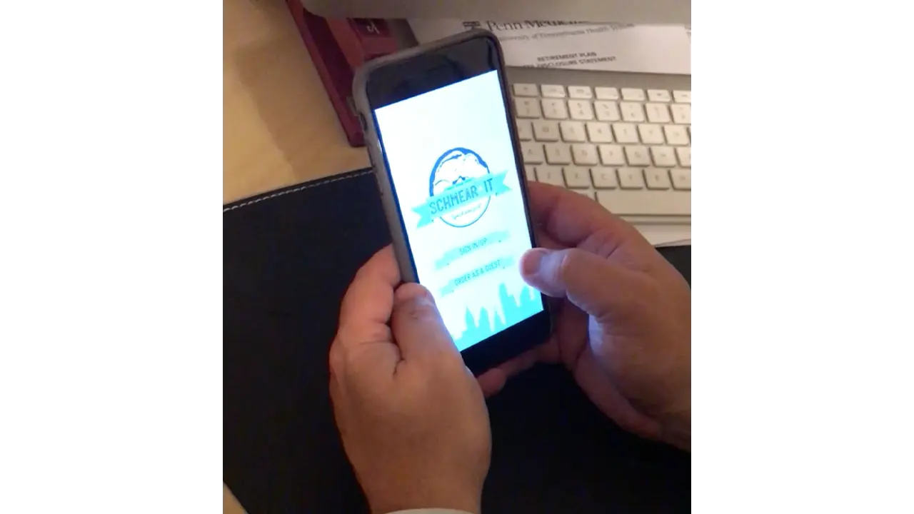 Person testing a prototype of the Schmear It app.